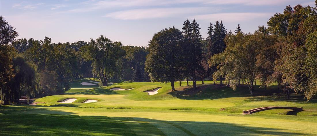 <b>Hole 14   |   Par 4   |   475 yards</b><br /> 
The toughest hole at St. George’s begins with a tee shot where you must avoid the out of bounds on the left, while negotiating a fairway that slopes hard to the creek on the right. Even the approach is tough because the small green is so flat and not receptive to shots.