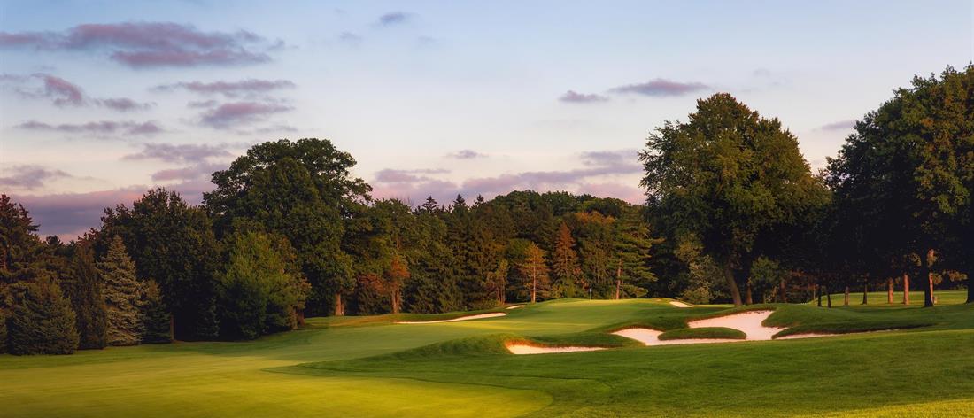 <b>Hole 17   |   Par 4   |   486 yards</b><br /> 
This hole began as a par five from the current back tee and now plays as an enormous par four. The toughest aspect is the narrow crowned green that sheds all but a perfect approach into the waiting bunkers on either side.